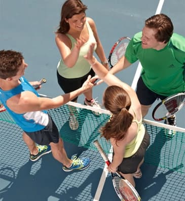 Группа людей собирается играть в теннис вместе с тренером по теннису - групповое занятие по теннису